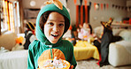 Halloween, portrait and kid with basket, candy and smile with celebration, home and giving. Dinosaur costume, bucket and child with happiness, sweets container and tradition with trick or treat event