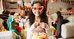 Halloween, portrait and girl with basket, kid and excited with celebration, home and happiness. Dress up, bucket and child with smile, sweets container and giving with costume, tradition and holiday