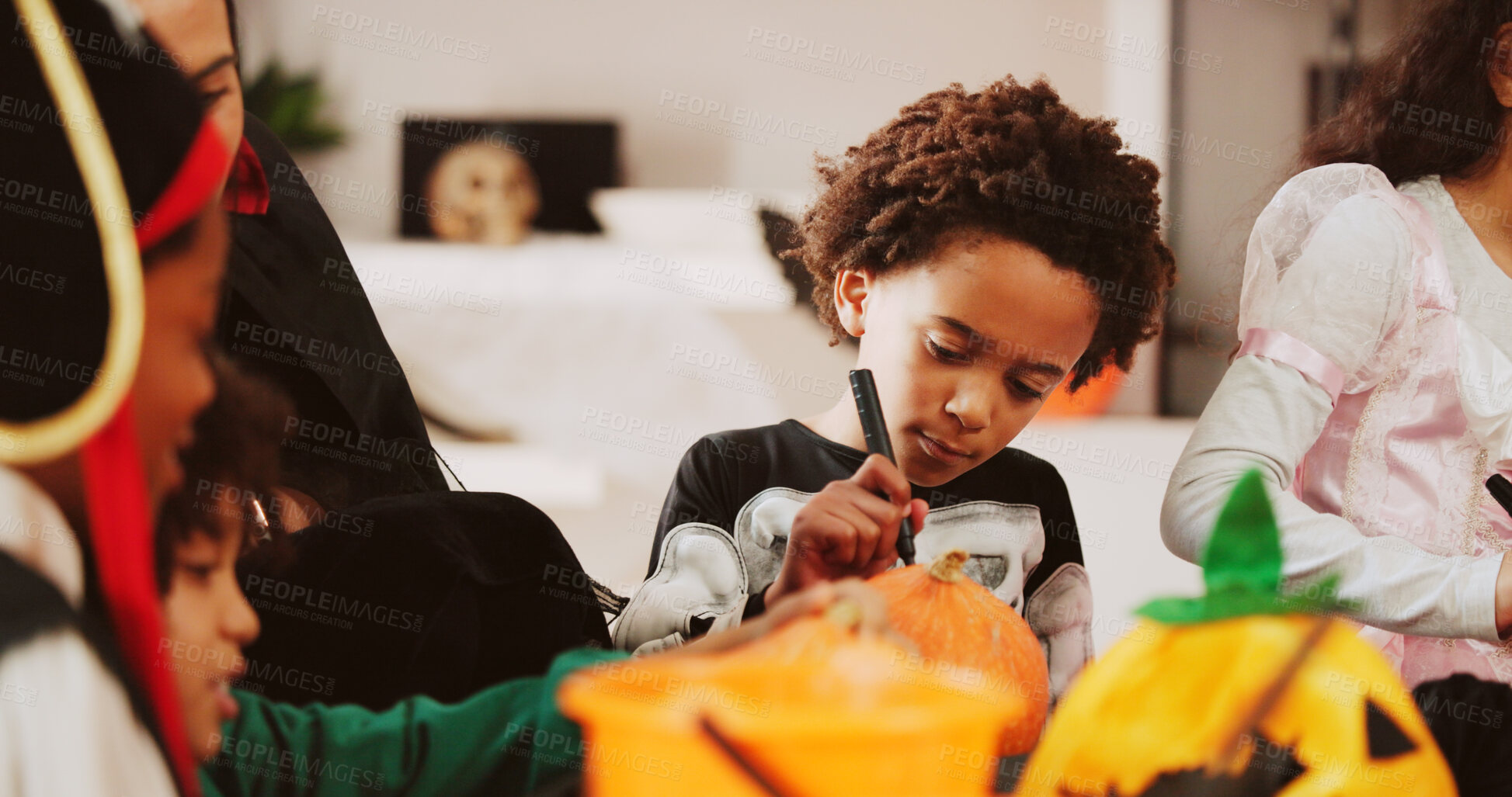 Buy stock photo Halloween, kids and boy with pumpkin, drawing and home with social gathering, creativity and party. Apartment, friends and children in lounge, costume event and decoration with celebration or writing