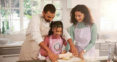 Buy stock photo Baking, smile and child with parents in kitchen for learning, bonding or development in home. Happy, cooking and girl kid with mother and father for preparing dessert together on weekend in house.