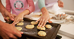 Baking, hands and tray with family in kitchen together for child development, learning or recipe. Cookies, dough and people with parents teaching daughter how to bake in apartment for cooking