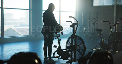 Buy stock photo Back, exercise bike and woman in gym for start of cardio training, fitness or workout routine. Getting ready, machine and stationary bicycle with person in health club for cycling or spinning class