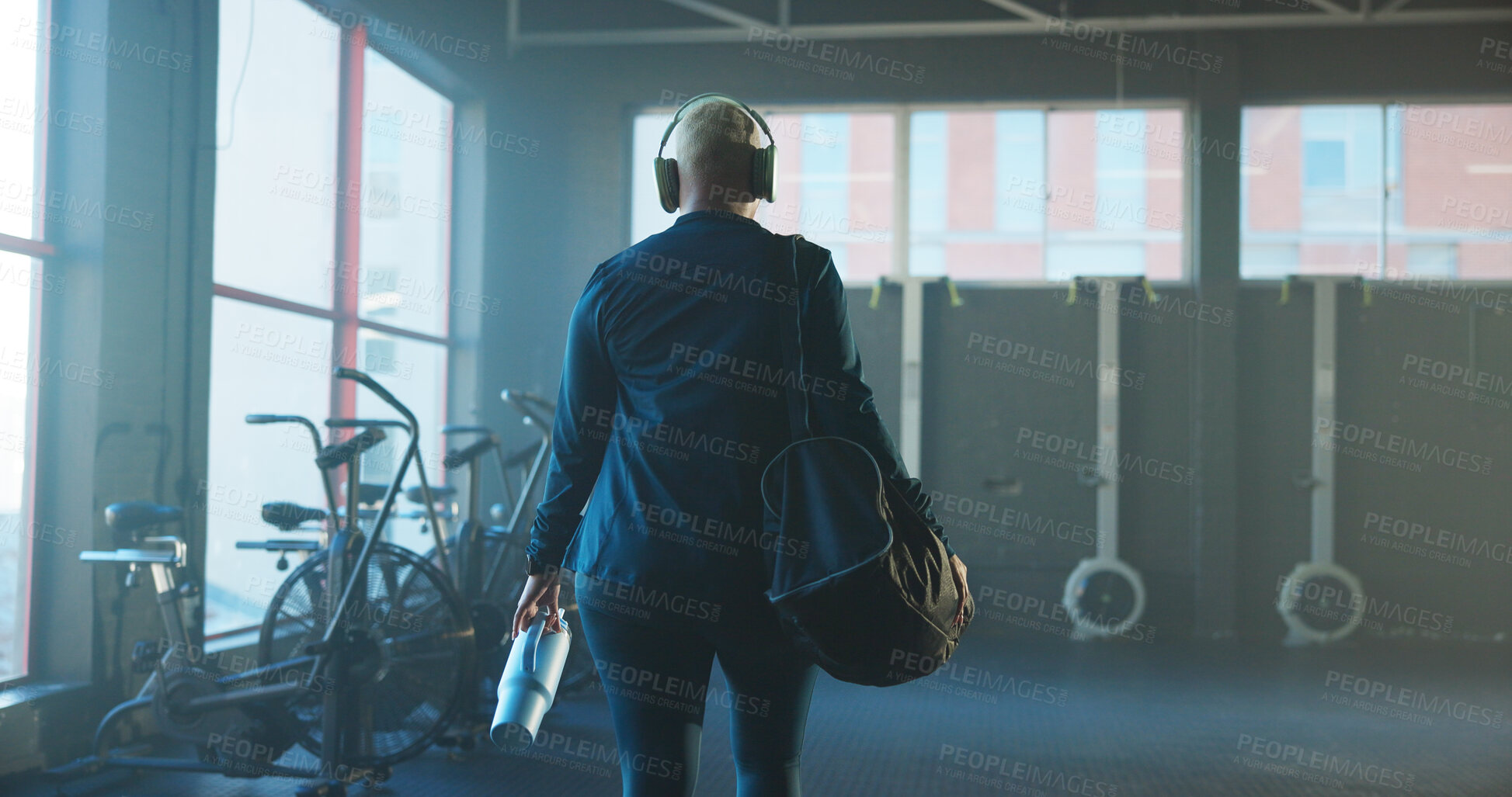 Buy stock photo Woman, back and walking with gym bag for workout preparation or getting ready to start exercise. Female person, water bottle and headphones with gear for fitness or begin training in health club
