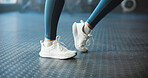 Warm up, ankle and woman in gym, fitness and shoes with training, wellness and routine. Closeup, sneakers and person in health club, stretching and workout with challenge, exercise and joint movement