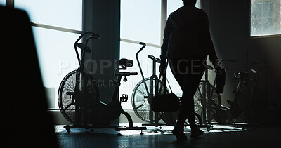 Buy stock photo Exercise bike, walking and woman in gym for start of cardio training, fitness or workout routine. Back, machine and stationary bicycle with person in health club for cycling or spinning class
