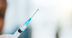 Drop, doctor and closeup of syringe in hospital for vaccine, virus prevention and immune protection. Healthcare, space and person with needle, injection or medicine for treatment, disease and health