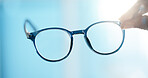 Hand, glasses and closeup for lens, eye care and vision with prescription, pov and test at clinic. Person, optometry and spectacles for visual wellness, eyesight and view with optical assessment