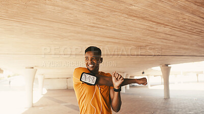 Buy stock photo Black man, smile and stretching arms for fitness, warm up and earphones for cardio preparation. African person, phone and athlete for sports podcast, workout and getting ready for exercise outdoor