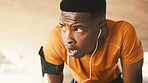 Tired, black man or breathing with earphones for fitness, fatigue or intense training in city. Active, male person or rest with sweat for workout break, exercise or physical activity in an urban town