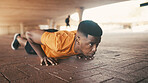 Athlete, black man and pushup outdoor for fitness, exercise and strength training. Male person, weightlifting and floor for sports workout, resilience performance and body balance for power challenge