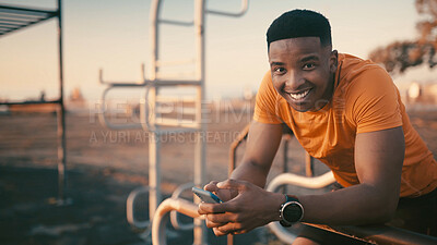 Buy stock photo Portrait, athlete and man with smartphone, outdoor gym and  smile for fitness, exercise or training. Happy, black person and research workout tips on mobile app, healthy and wellness in Nigeria