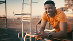 Portrait, fitness and man with smartphone, outdoor gym or smile for exercise, athlete and training. Happy, black person and research workout tips on mobile app, healthy and wellness in Nigeria
