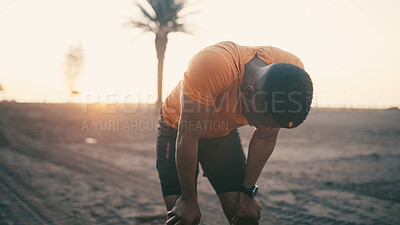 Buy stock photo Tired, fitness and black man with rest, outdoor and breathing with wellness, recovery and exercise. Fatigue, relax and African person with training, healthy body and exhausted with workout or sports
