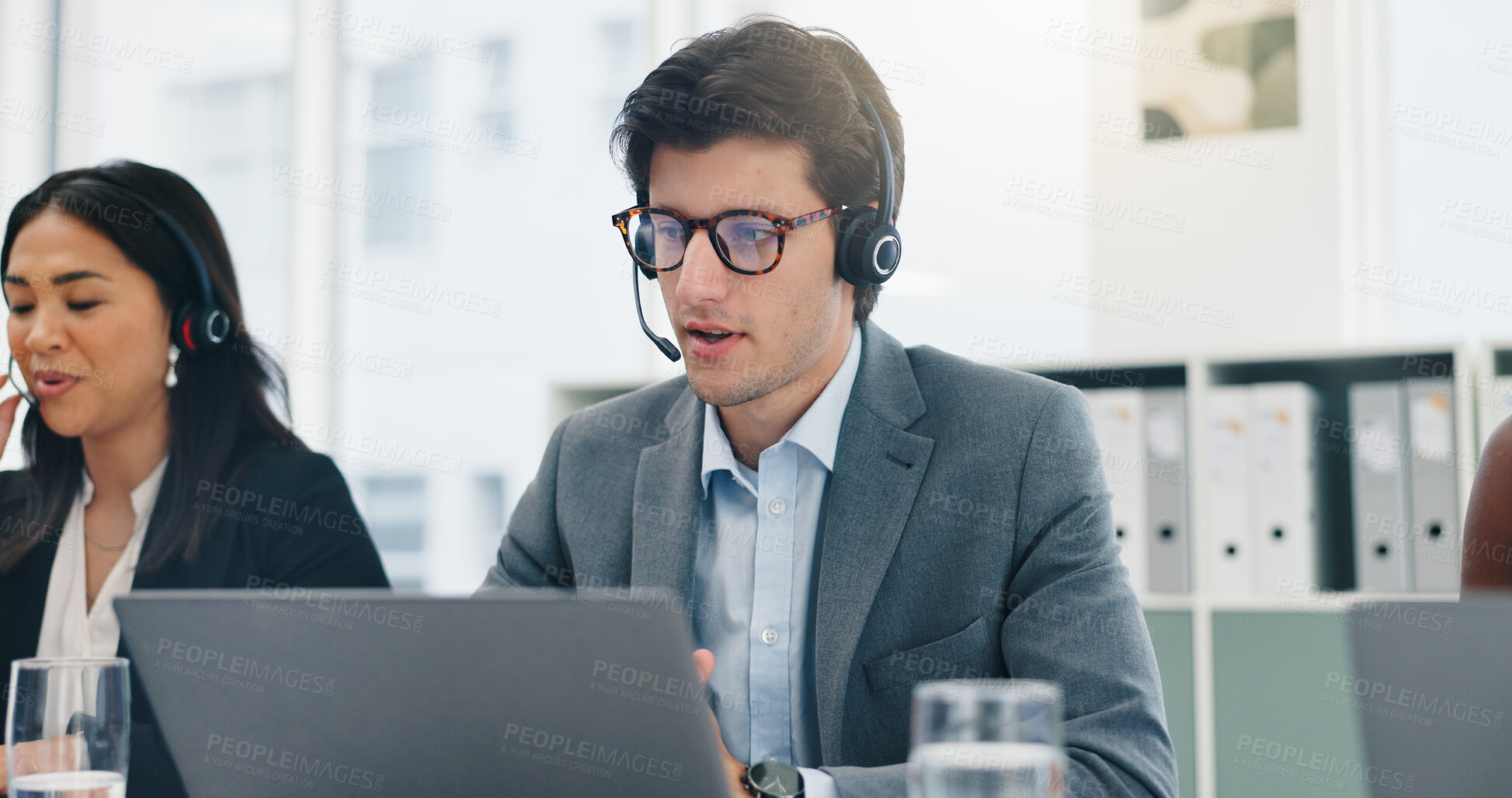 Buy stock photo Microphone, team and man with laptop in call center for contact us, order processing or online help. Customer service, consultant or tech for inbound query assistance, account management or coworking