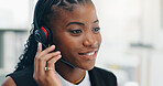 Headset, black woman and call center agent in office with crm, contact or consultation. Mic, happy or African female technical support consultant with communication for customer service in workplace.