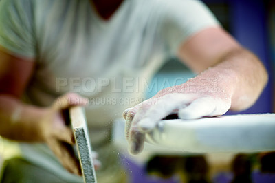 Buy stock photo Hands, person and sanding foam in workshop for surfing equipment, design process and handmade. Surfboard shaper, small business owner and sandpaper in garage for quality production and custom craft