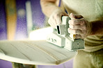 Hands, sanding and foam with dust, surfboard and creativity for skills, talent and hobby. Man, artist and entrepreneur with craftsman for design manufacturing and custom work for artisan craft