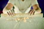 Hands, person and sanding surfboard with tool to smooth surface, shaping process and repair texture. Burnisher, wood or skill for diy restoration, board maintenance and polish craft to prepare finish