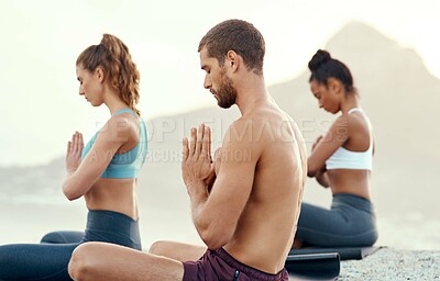 Buy stock photo Fitness, meditation and yoga with people on beach for mental health, peace or wellness in morning. Exercise, training and zen with sporty friends on mat at coast by ocean for balance and mindset