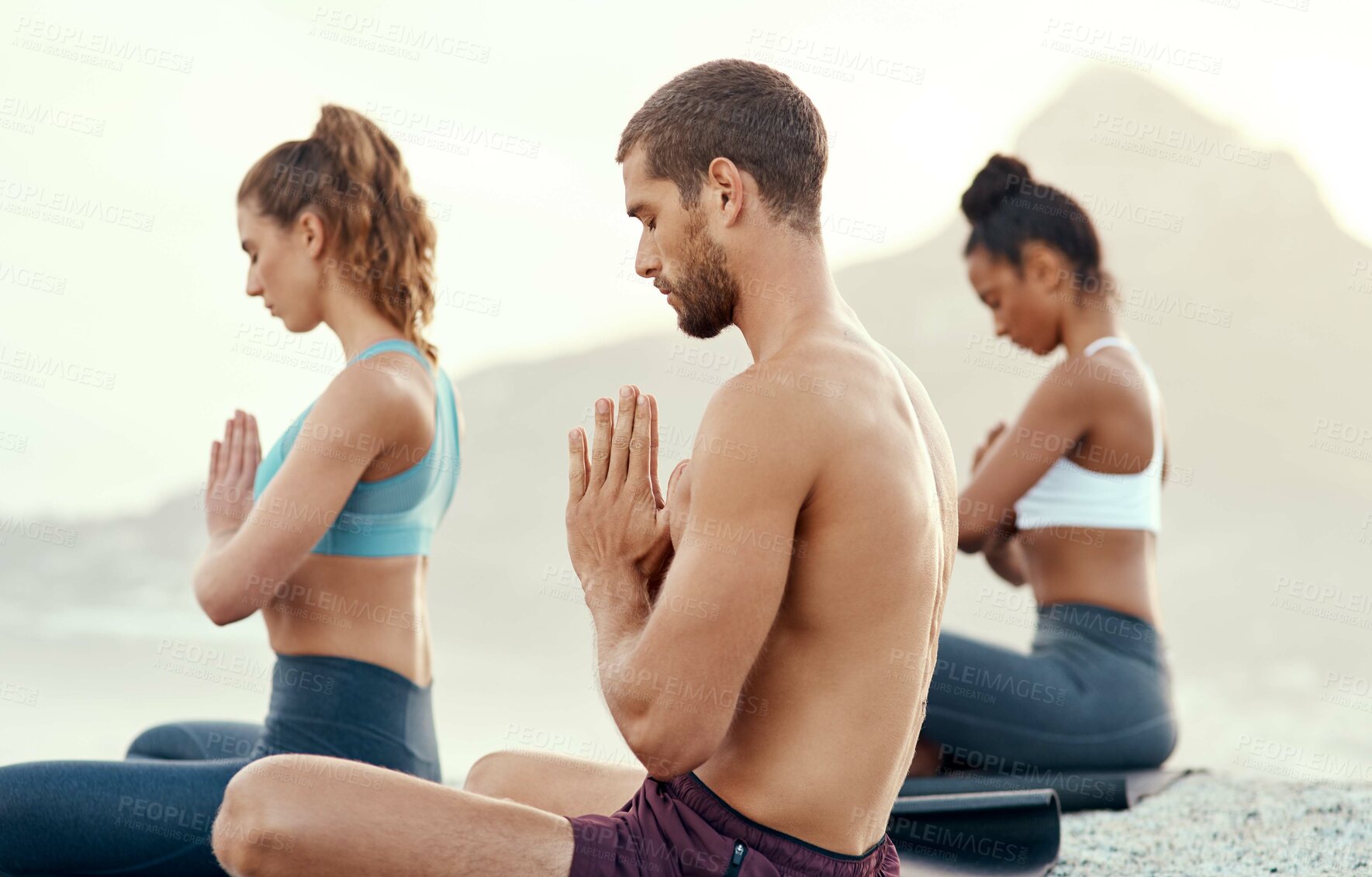 Buy stock photo Fitness, meditation and yoga with people on beach for mental health, peace or wellness in morning. Exercise, training and zen with sporty friends on mat at coast by ocean for balance and mindset