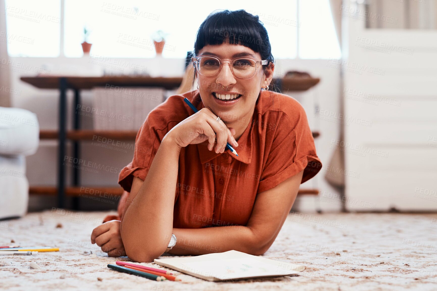 Buy stock photo Happy, woman and hands for drawing with pencils and paper on floor for relax, hobby and creative outlet at home. Female person, smile and sketching in colouring book for inspiration, art and fun