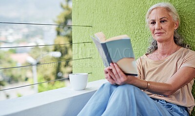 Buy stock photo Mature, woman and book for reading on balcony for retirement, relax and peace in apartment. Senior female person, novel and morning in home for calm, tea or coffee and smile for story or fantasy
