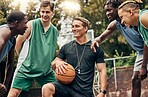 Basketball coach talking to his team during a training session on outdoor court. Teamwork, motivation and inspiration speech from trainer for basketball team having fun and learning in a sports game