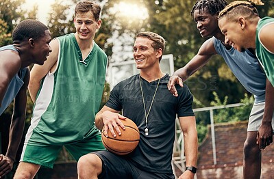Buy stock photo Basketball coach talking to his team during a training session on outdoor court. Teamwork, motivation and inspiration speech from trainer for basketball team having fun and learning in a sports game