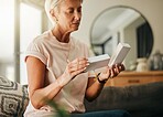 Healthcare, retirement with woman and medicine in living room for wellness, medical and care. Senior, insurance and health with elderly person reading pills information for treatment prescription