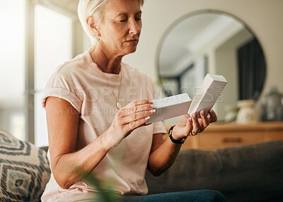 Buy stock photo Healthcare, retirement with woman and medicine in living room for wellness, medical and care. Senior, insurance and health with elderly person reading pills information for treatment prescription
