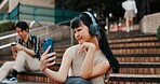 Woman, selfie and headphones on stairs in city with streaming, memory and post on mobile app. Girl, person and influencer with live stream, profile picture or photography with music on steps in Japan