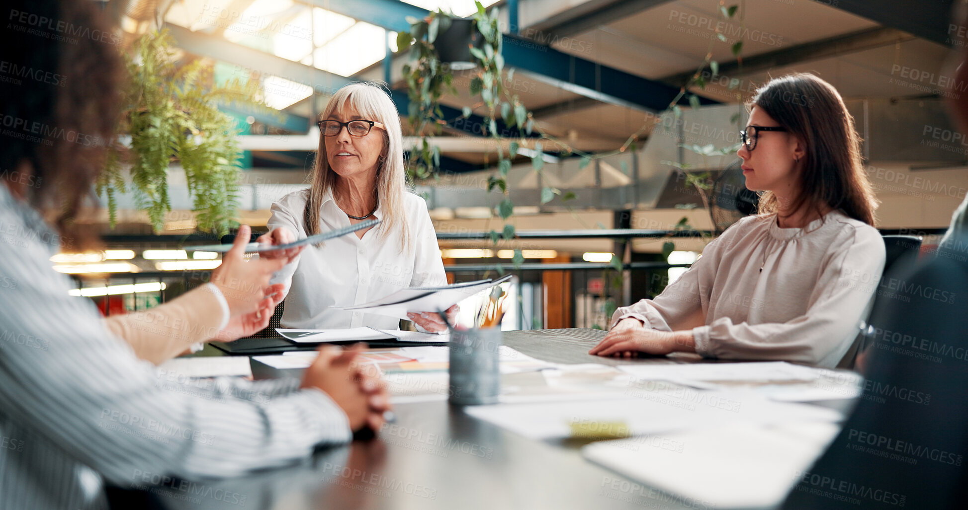 Buy stock photo Portfolio, ideas or designers talking in meeting for creative project, startup or feedback. Review, interior design paperwork and people with teamwork for brainstorming, planning or collaboration