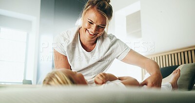 Buy stock photo Home, mother and child with tickle for playing, laughing and bonding together with happy smile. Bedroom, mom and girl with funny game for connection, childhood activity and support for trust or relax