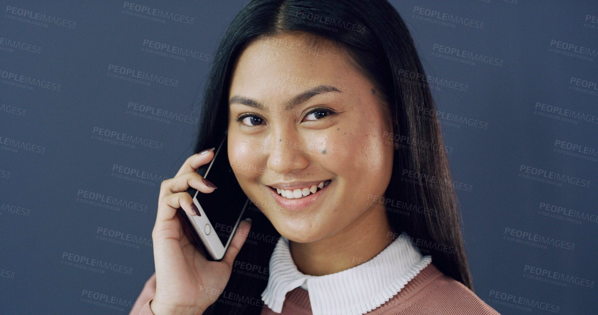 Buy stock photo Business, phone call and portrait of woman in studio for conversation, negotiation or networking. Communication, contact and smile of Asian employee isolated on blue background for mobile update