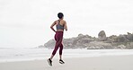 Woman, running and exercise at beach, back or training with space, sky and outdoor for routine. Person, workout and fitness in summer for wellness, cardio challenge and jog by ocean in Australia