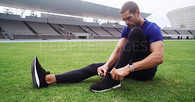 Buy stock photo Exercise, shoes and tie with man on field in stadium for start of cardio training or workout. Fitness, footwear and laces with athlete or runner getting ready for competition or sports in arena