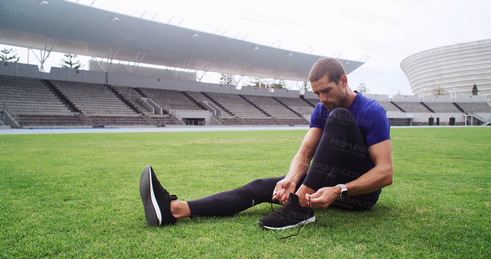 Buy stock photo Fitness, shoes and tie with man on field in stadium for start of cardio training or workout. Exercise, footwear and laces with athlete or runner getting ready for competition or sports in arena