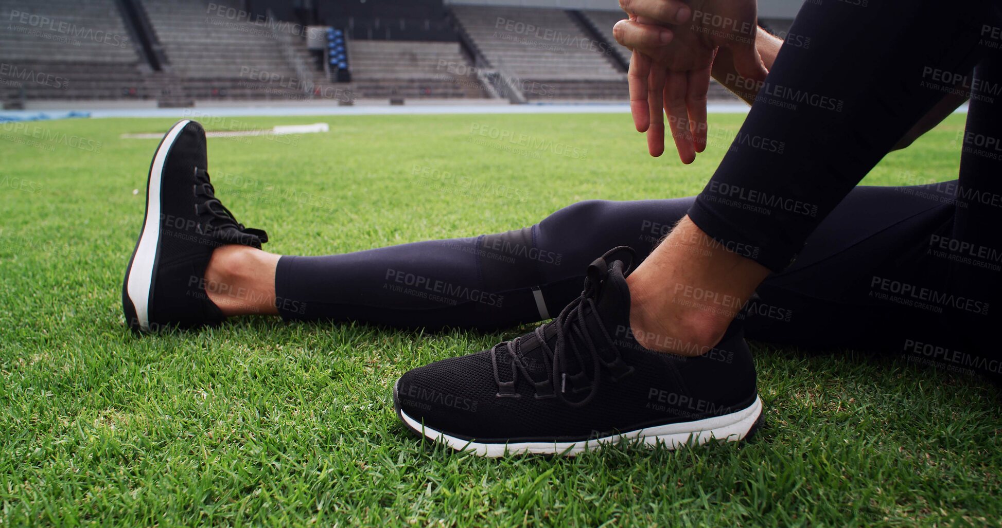 Buy stock photo Exercise, hands and shoes with person on grass in stadium for start of competition or tournament. Fitness, getting ready and sneakers with athlete or runner outdoor on field for sports event closeup