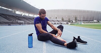 Buy stock photo Fitness, ankle pain and man in stadium for injury, emergency or physical risk with training. Exercise, accident and massage with athlete or runner on track at venue for fatigue or muscle cramp