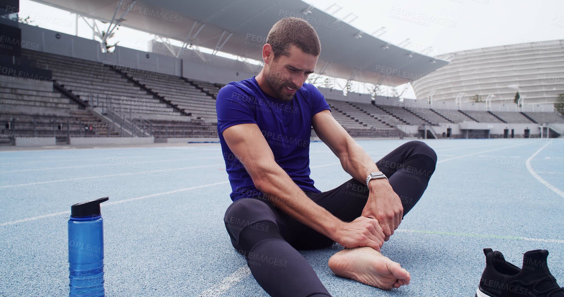 Buy stock photo Exercise, leg pain and man in stadium for accident, emergency or physical risk with training. Fitness, injury and massage with athlete or runner on track at venue for workout, fatigue or muscle cramp