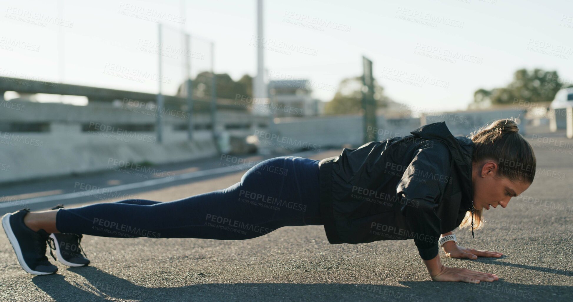 Buy stock photo Woman, push up and exercise in street for fitness, challenge and routine for wellness on bridge. Person, outdoor and workout in city with muscle development, health or training on ground in Spain