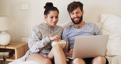 Buy stock photo Couple, laptop and movie with popcorn on bed for weekend break, series subscription and bonding. Home, happy people and tech with snacks in bedroom for watching film, relationship and streaming show