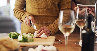 Buy stock photo Hands, couple cooking and chopping board with vegetables, tablet and online tutorial. Technology, man and woman cut mushrooms with guide, organic food or healthy recipe for meal prep in home kitchen
