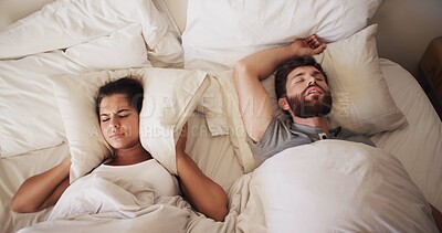 Buy stock photo Couple, bed and woman with man snoring, loud or noise with frustrated partner in home. Person with sleep apnea, above angry or annoyed wife for sleepless and awake, upset and cover ears at house 