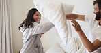 Bedroom, couple laugh and pillow fight in home for love, playful partner and excited together. Morning, man and woman with cushion for game in bed, funny and bonding with happiness in apartment