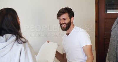 Buy stock photo Happy, couple and pillow fight in bedroom for love, playful partner and together in morning. Home, man and woman with cushion for game, smile and bonding for connection in apartment on weekend