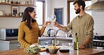 Happy, couple and cheers with wine, kitchen and celebration for meal prep, culinary skills and home. People, together and toast with alcohol for date, cooking and ingredients for dinner in house