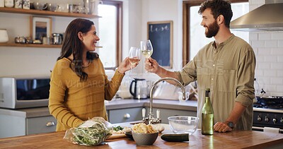 Buy stock photo Happy, couple and cheers with wine, kitchen and celebration for meal prep, culinary skills and home. People, together and toast with alcohol for date, cooking and ingredients for dinner in house