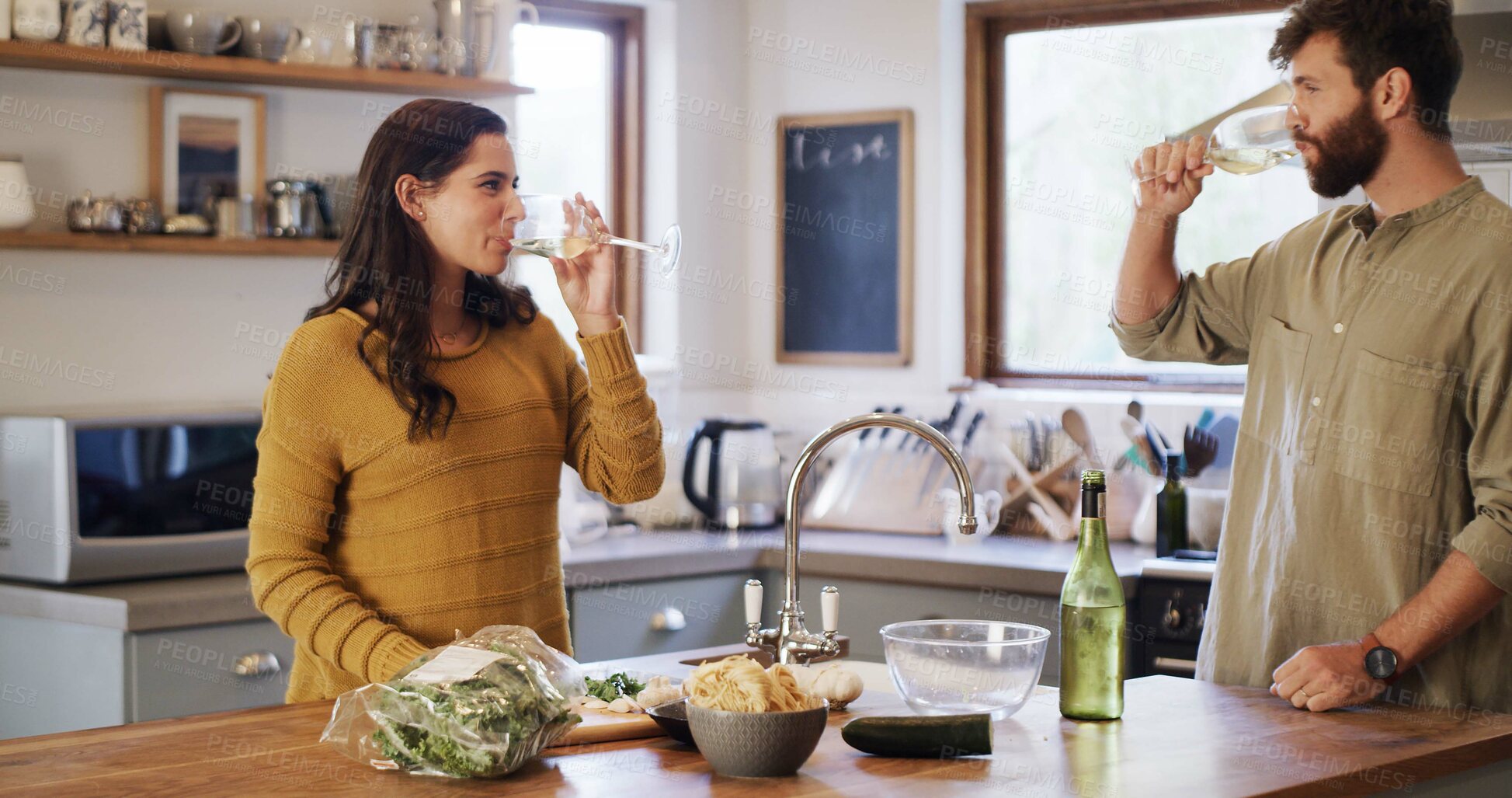 Buy stock photo Drinking, wine and couple in kitchen, cooking and ingredients for meal prep, bonding and commitment. People, together and alcohol in home, nutrition and recipe for dinner, relationship or marriage