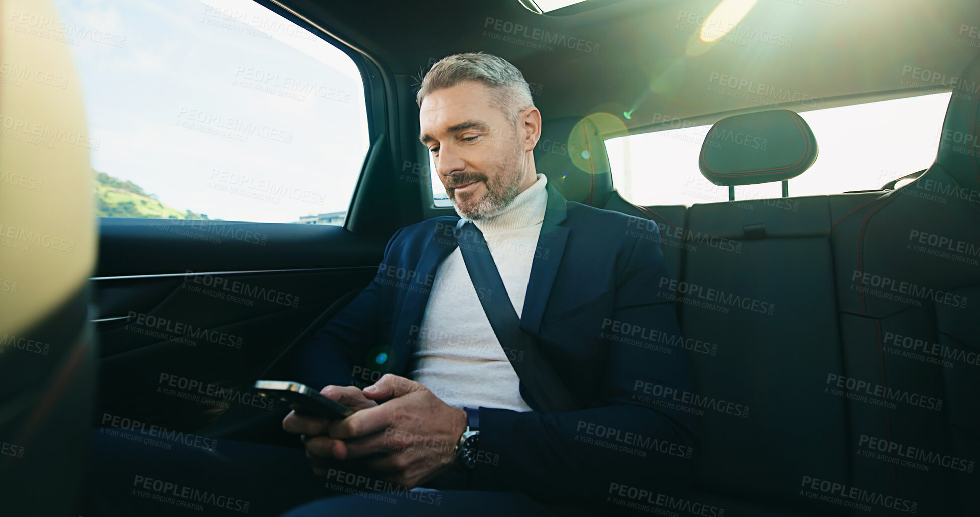 Buy stock photo Commute, drive and phone with business man in car for agenda, schedule or text message. Reading, ride share and travel with mature passenger in backseat for communication or transport with lens flare